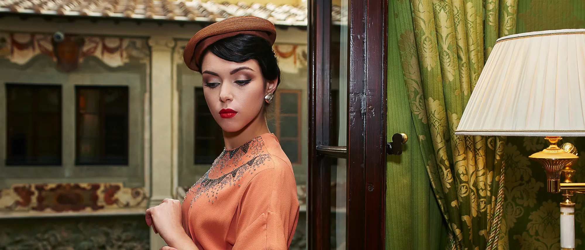 Vintage style portrait of an elegant woman inside a classic Florentine interior