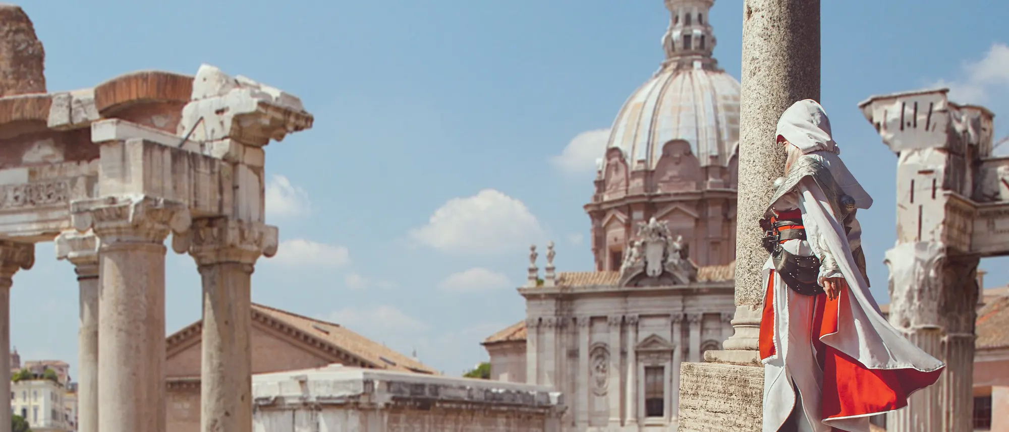 Costumed Assassin cosplay character inspired by Roman history standing among ancient ruins in Rome