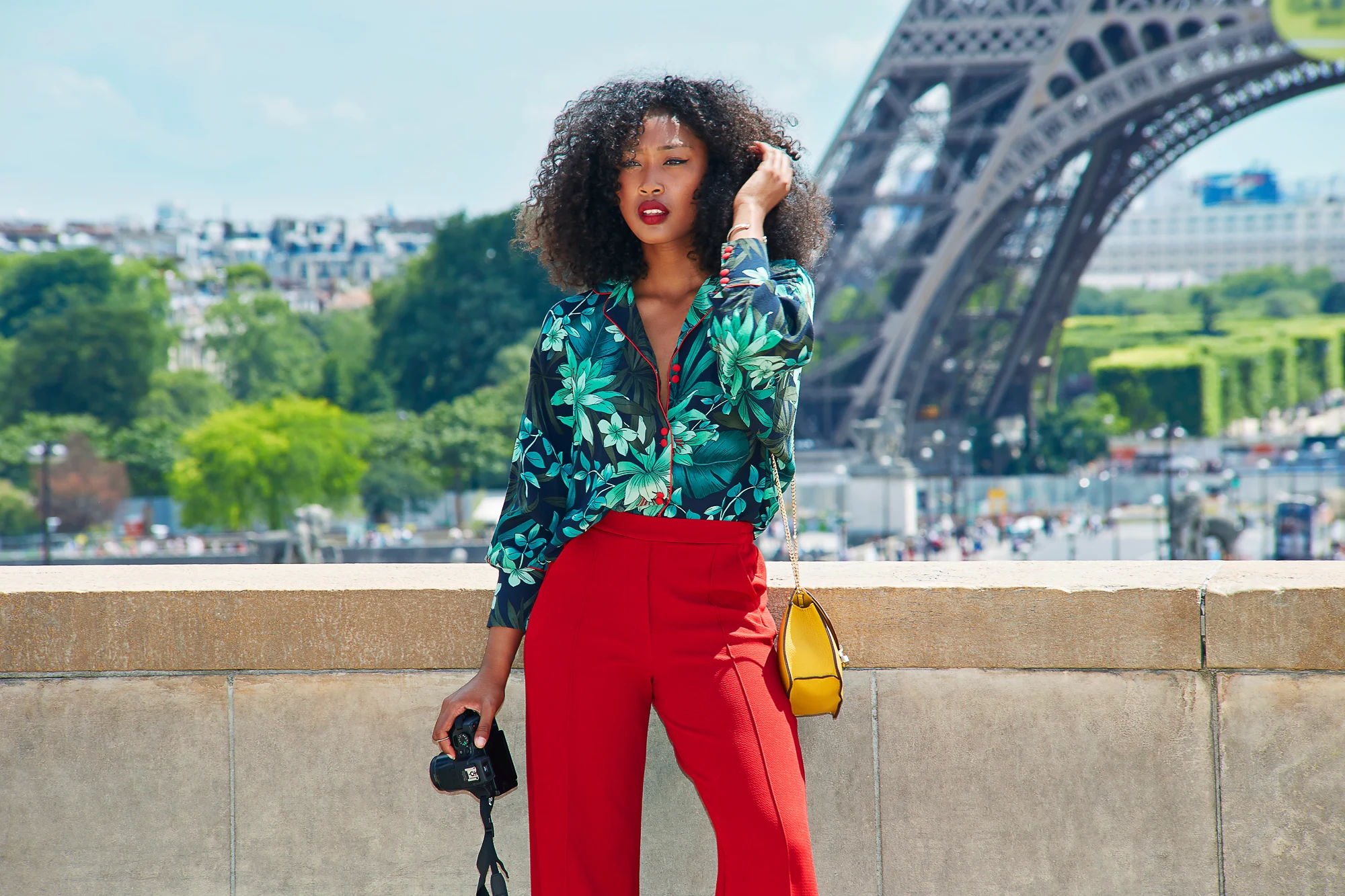 Editorial fashion portrait with the Eiffel Tower in Paris featuring a stylish model in a modern city setting