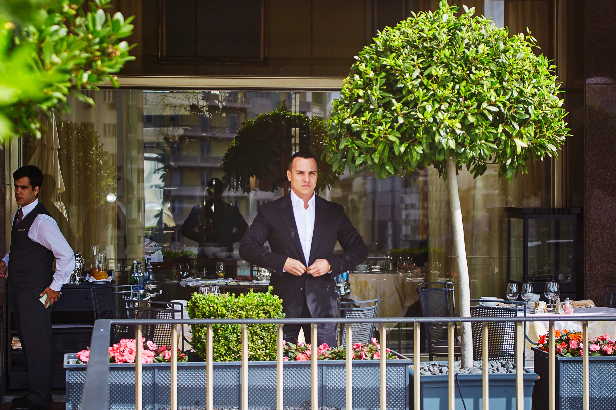 Elegant man in a suit standing on the terrace of a luxury restaurant (Pavel Manylov)