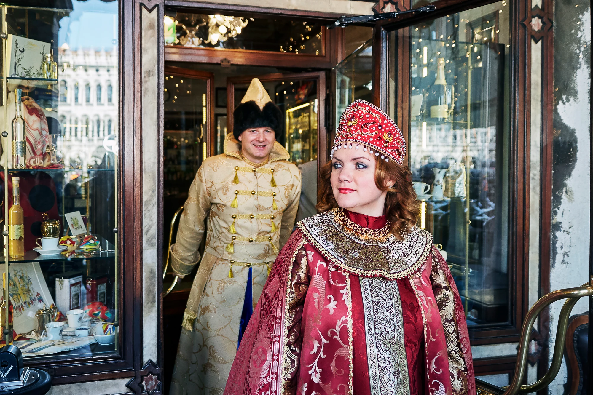 Couple in ornate Russian costumes during Venice carnival in the city center