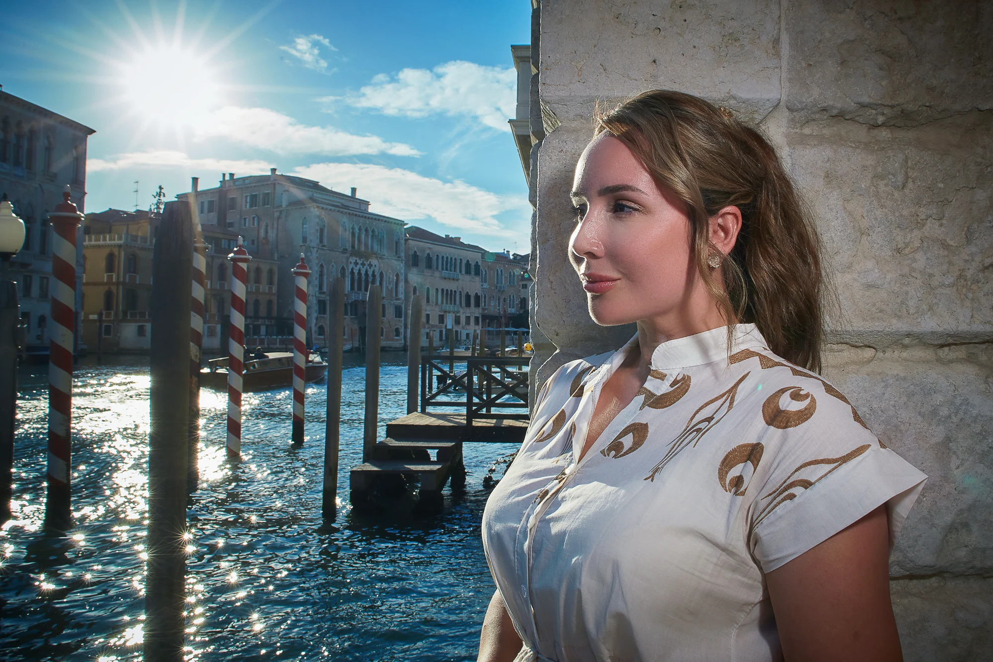 Elegant woman in evening light with Venice Grand Canal in the background