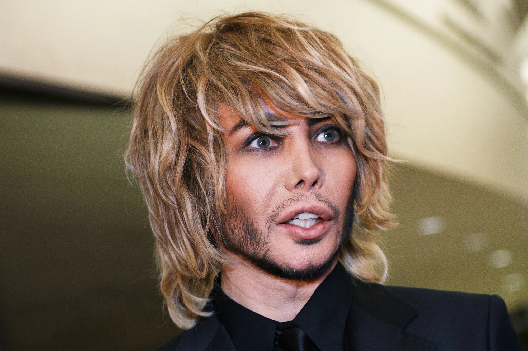 Glamorous portrait of Sergey Zverev with dramatic makeup and hairstyle at a social event