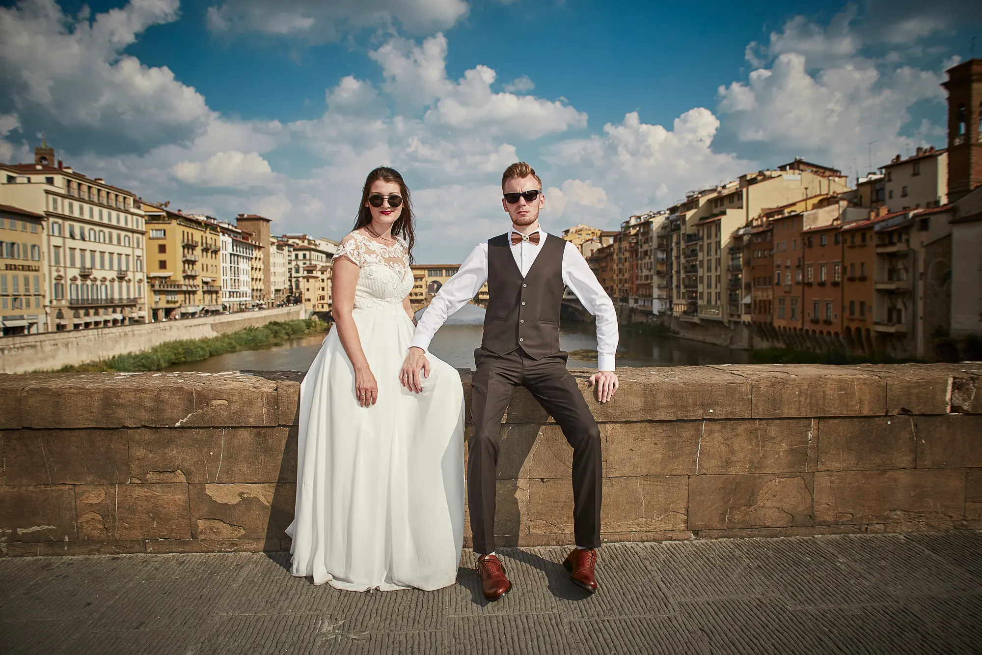 Bride and groom in sunglasses on Ponte Vecchio bridge, wedding photographer in Florence Italy