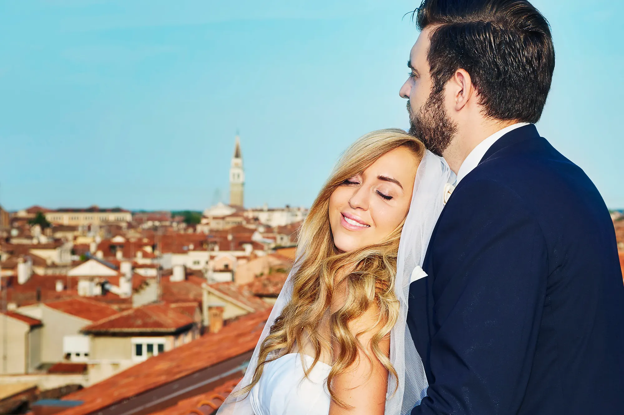 Venice wedding photographer capturing bride on rooftop terrace with city skyline