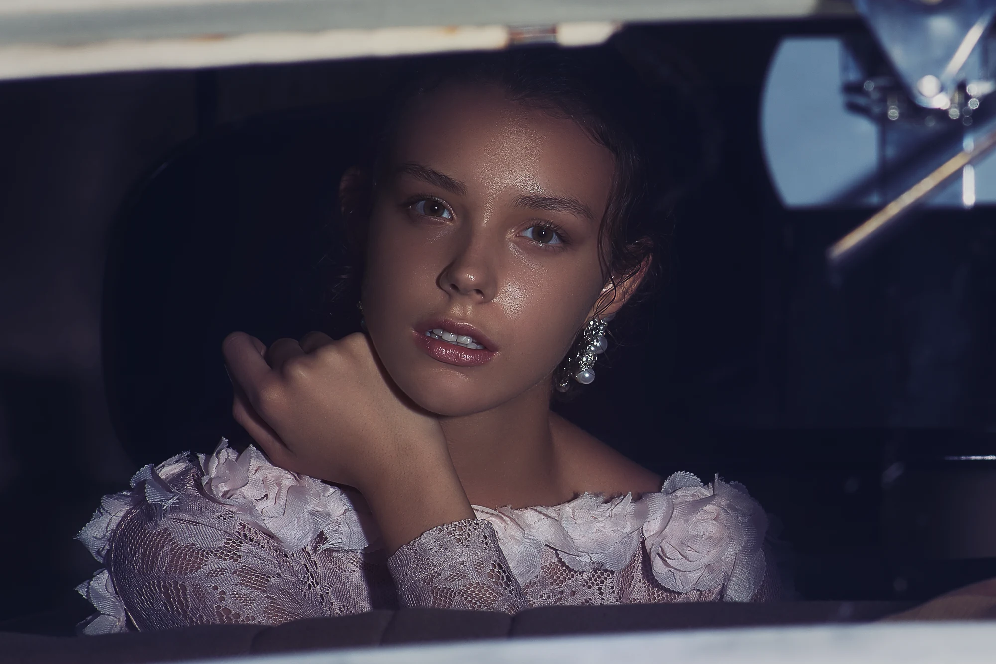 Wedding photographer in Italy shooting dramatic bridal portrait in vintage car at night