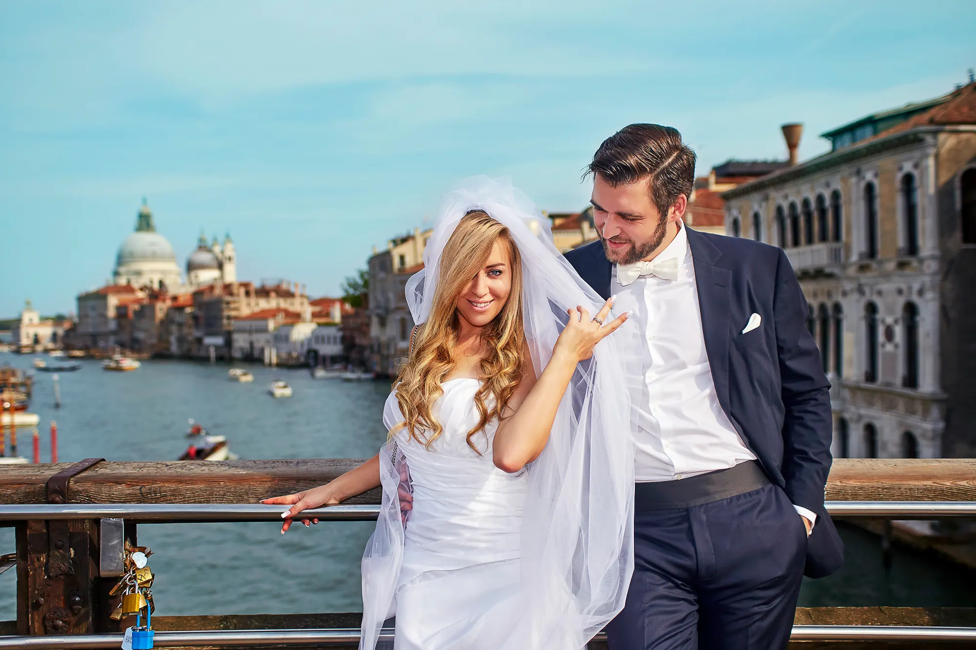Wedding photographer in Venice Italy capturing bride and groom on Accademia bridge with Grand Canal view